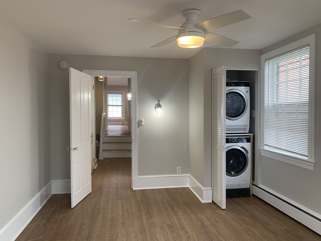 a laundry room with a washer and dryer and a ceiling fan