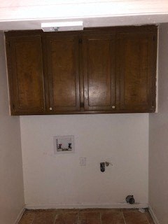a kitchen with wooden cabinets on top of a wall