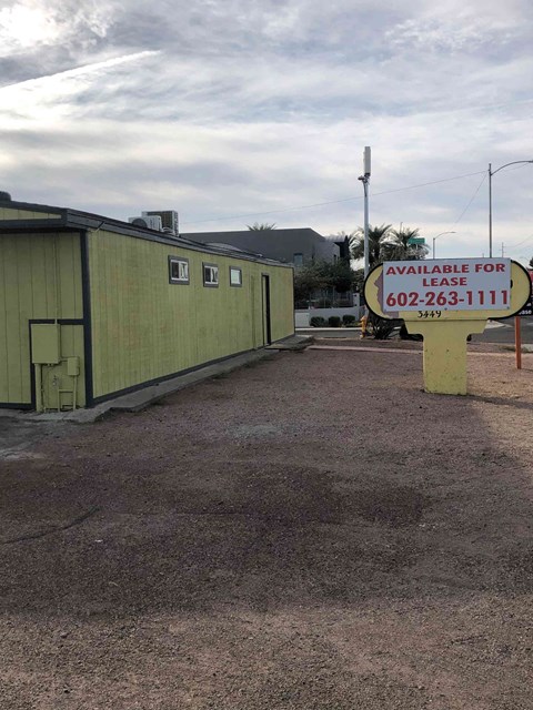 a sign is in front of a green building
