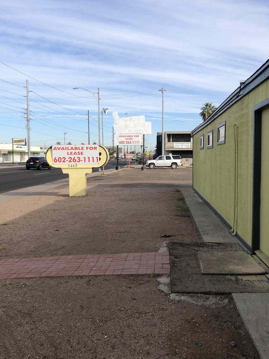 a sign sitting on the side of a street