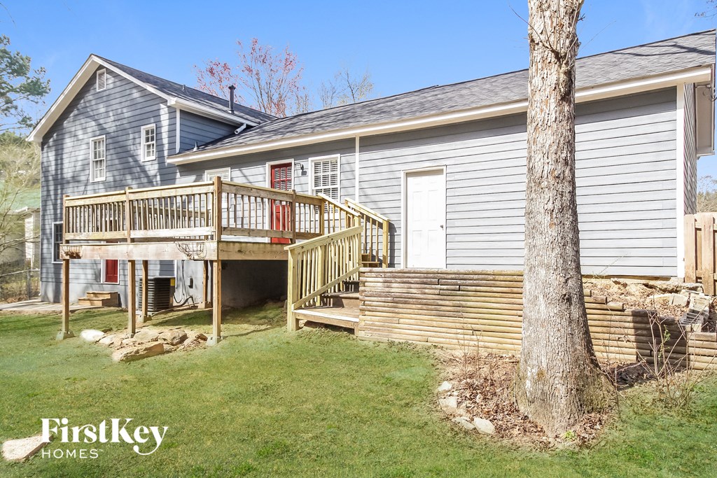 a backyard with a deck and a house with a porch