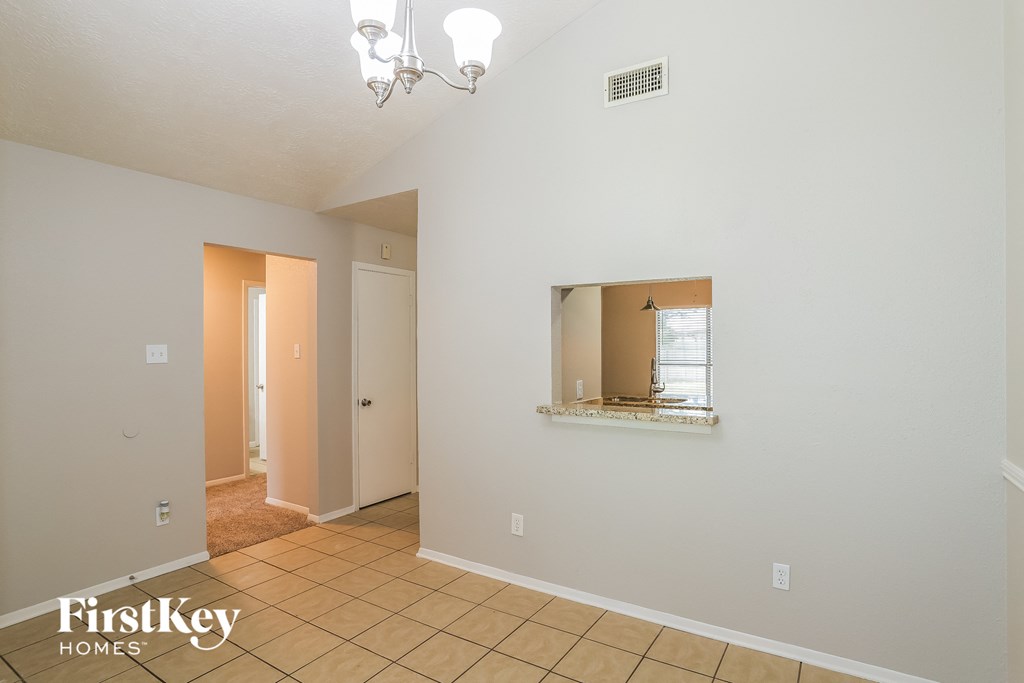 A room with a mirror and a window.