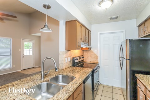 A kitchen with granite countertops and a sink.