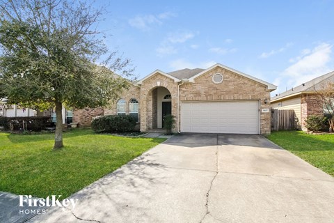 a brick house with a driveway and a garage door