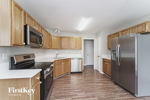 a kitchen with wooden cabinets and stainless steel appliances