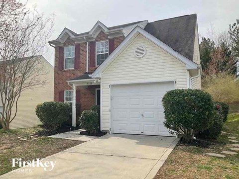 the front of a house with a white garage door
