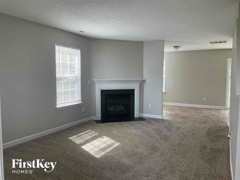 an empty living room with a fireplace