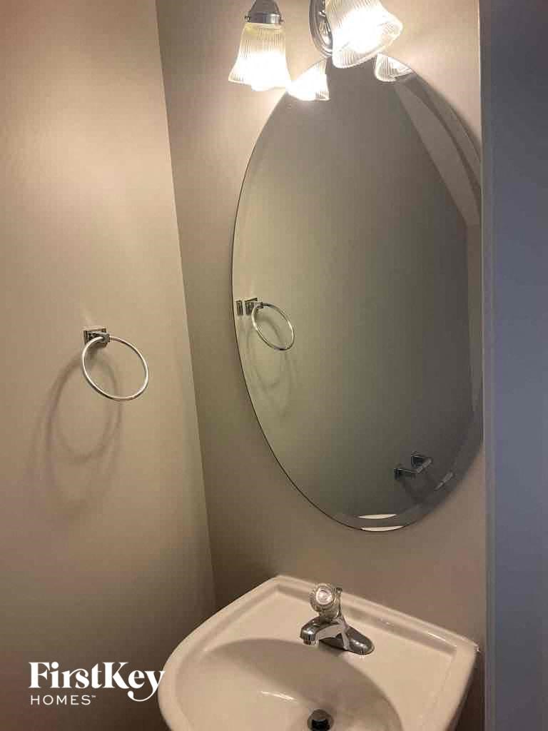 a small bathroom with a mirror and a sink