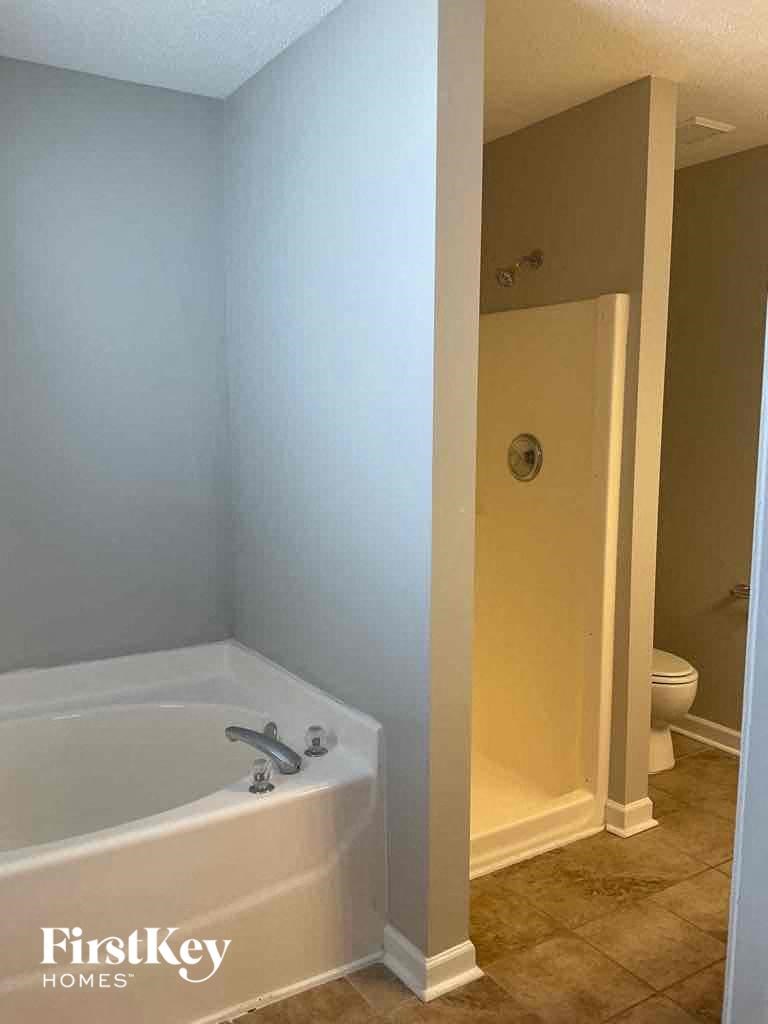 a full view of a bathroom with a tub and a shower