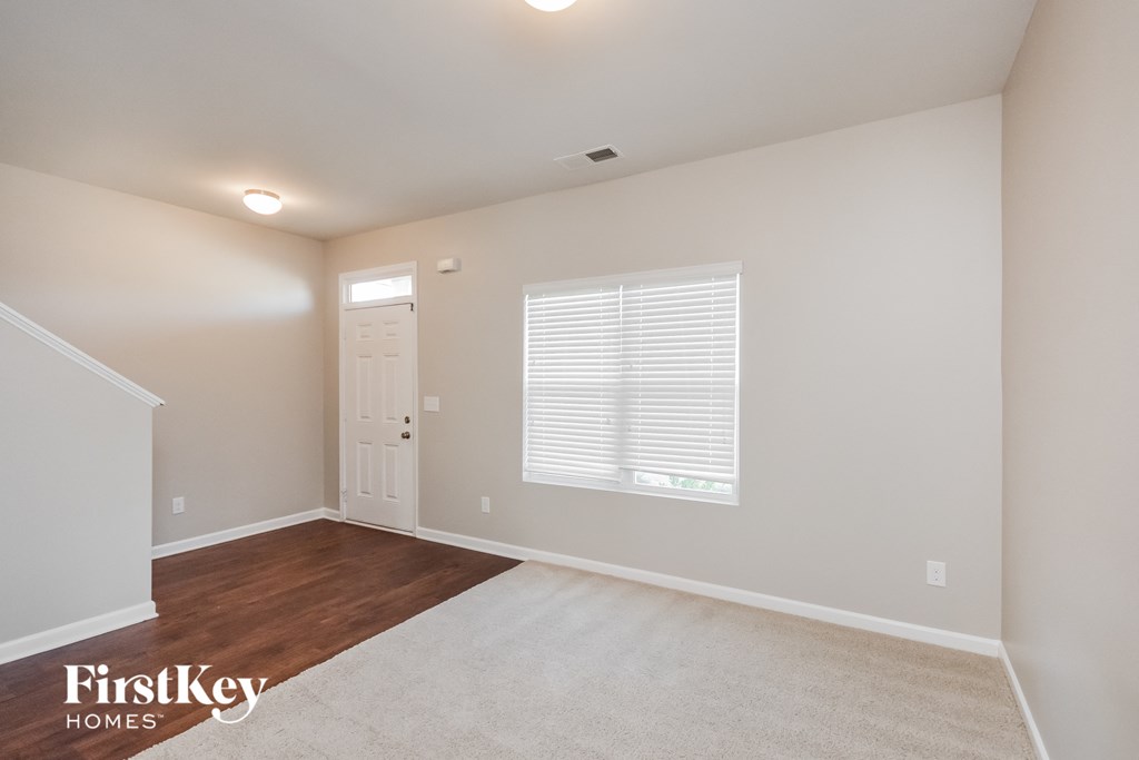 the spacious living room with a door to the laundry room
