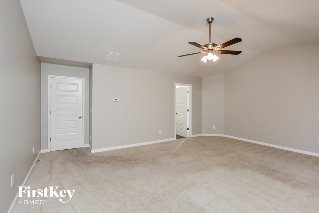 the master bedroom is spacious and has a ceiling fan