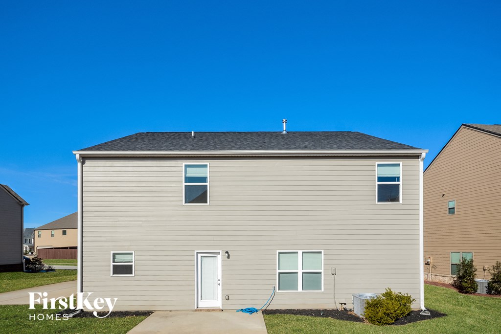 a tan house with a blue sky in the background