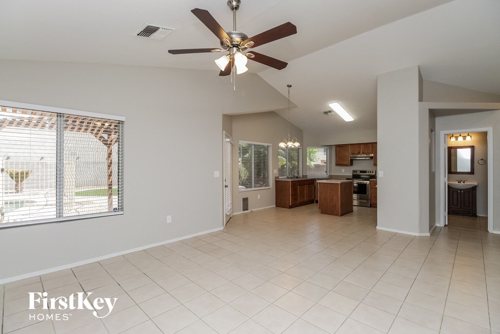 an open kitchen and living room with a ceiling fan