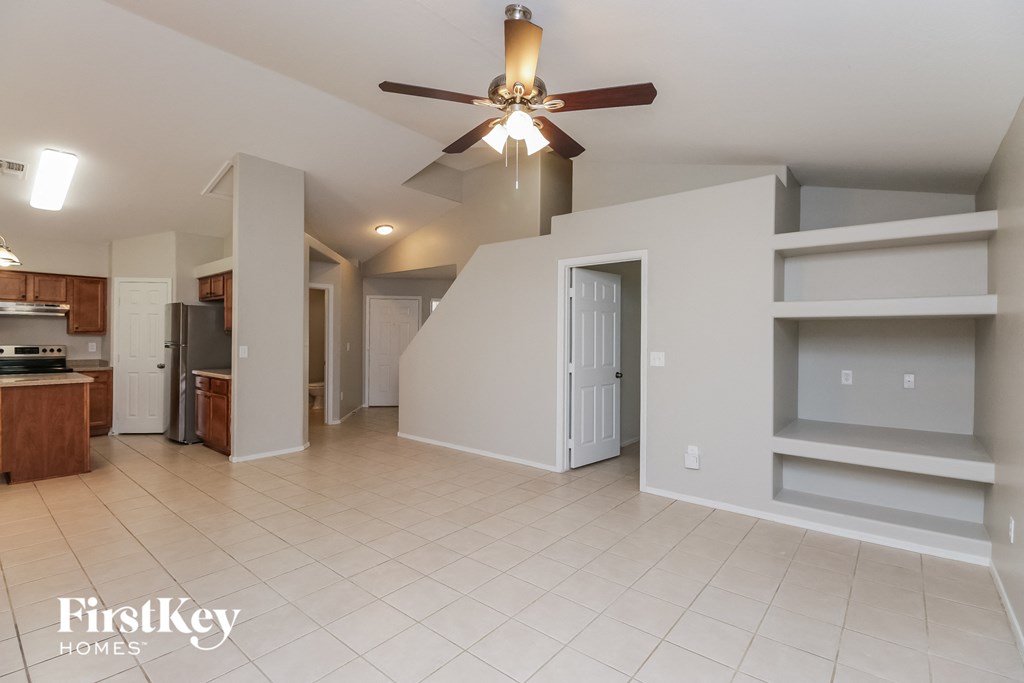 an open kitchen and living room with a ceiling fan