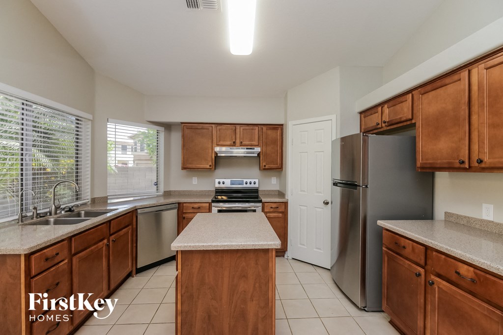 an updated kitchen with stainless steel appliances and wooden cabinets