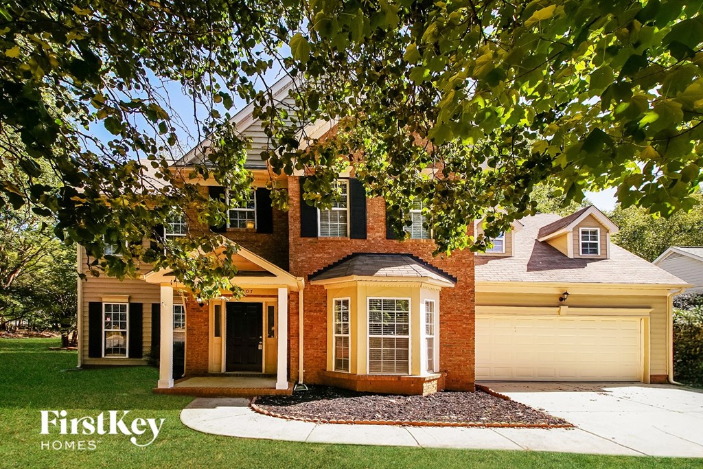 A house with a brick chimney and a garage door is shown.