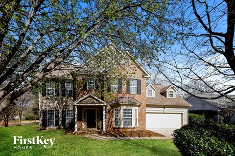 a large brick house with a white garage door