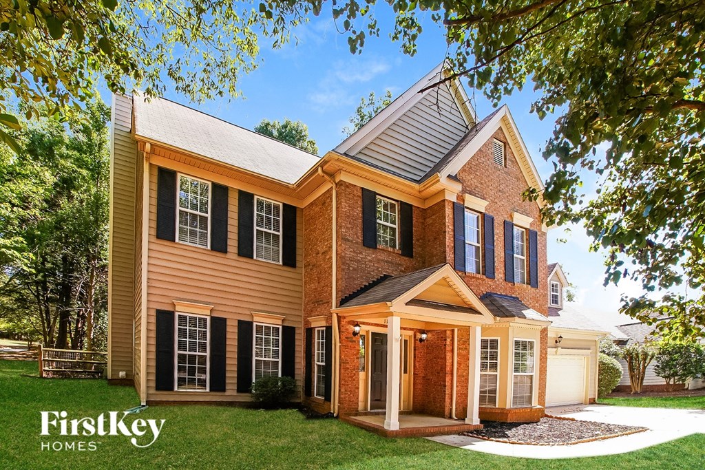 A house with a brown and black exterior is shown with the words "FirstKey Homes" on the bottom left.