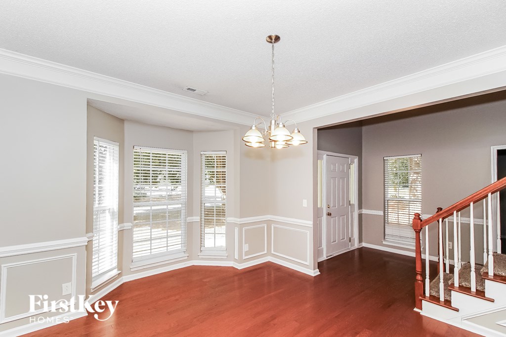 A well lit foyer with a staircase.