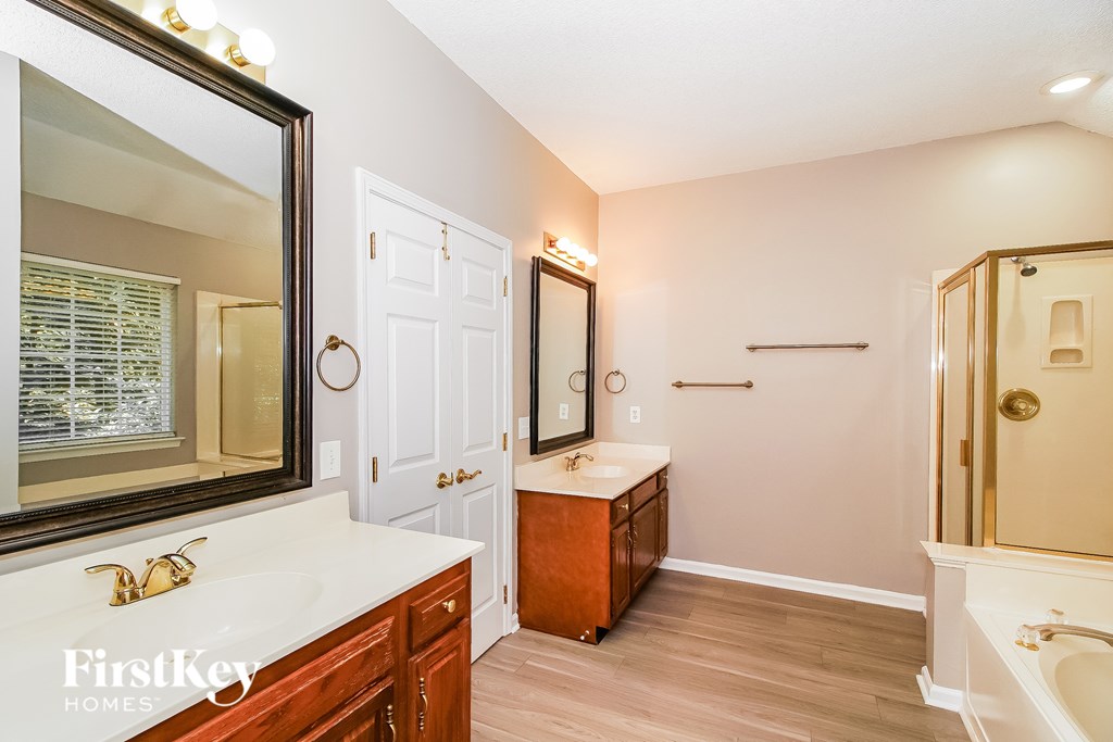 A bathroom with a white sink and a mirror.