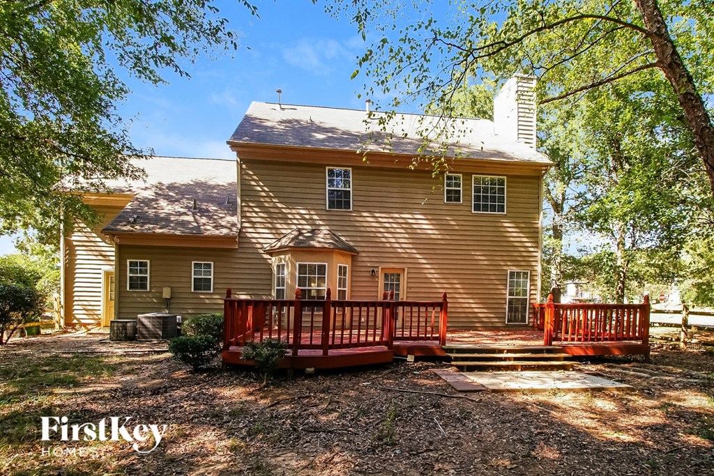A house with a red fence in front of it.