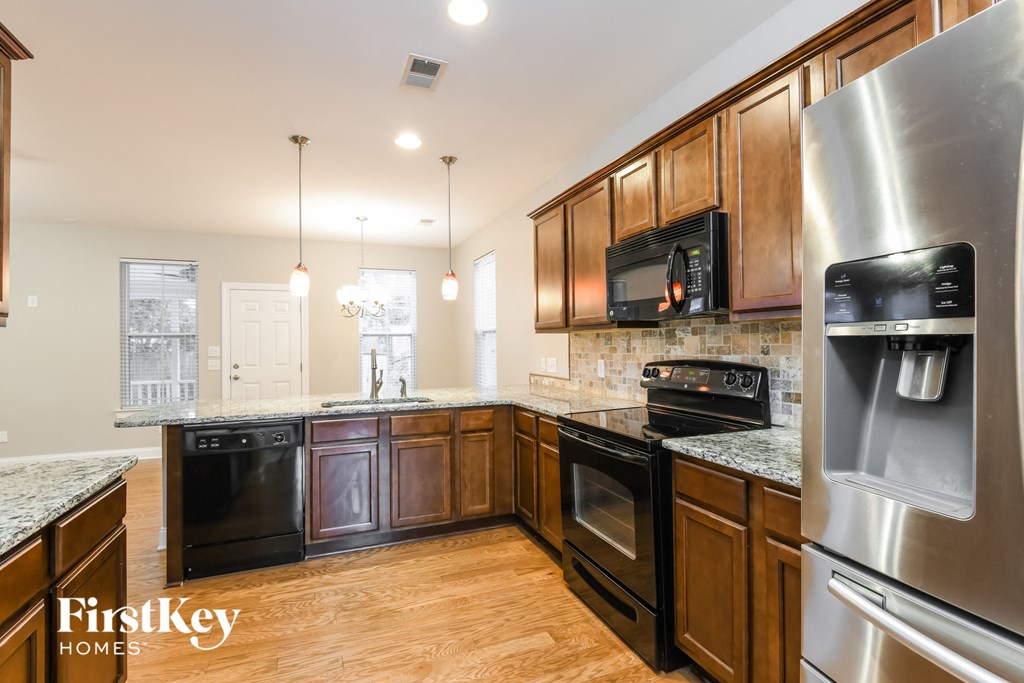 a kitchen with stainless steel appliances and wooden cabinets