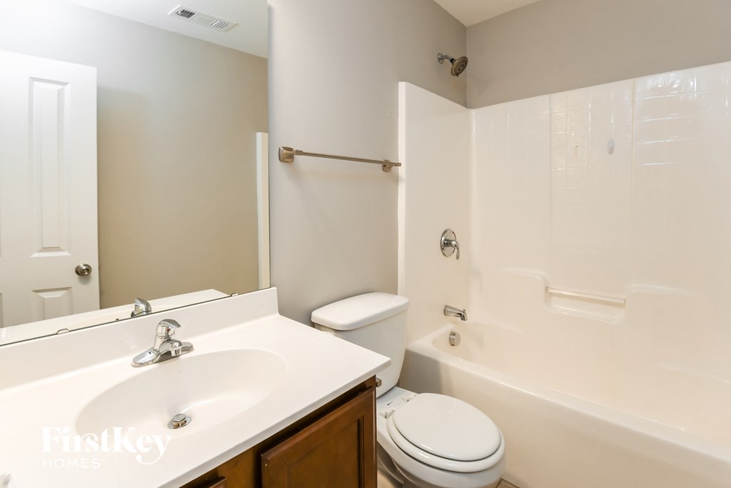 a bathroom with a sink and a toilet and a tub