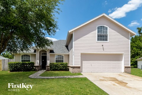 A house with a garage and a driveway is for sale.