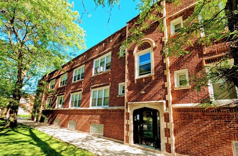 A red brick building with a black door and windows.