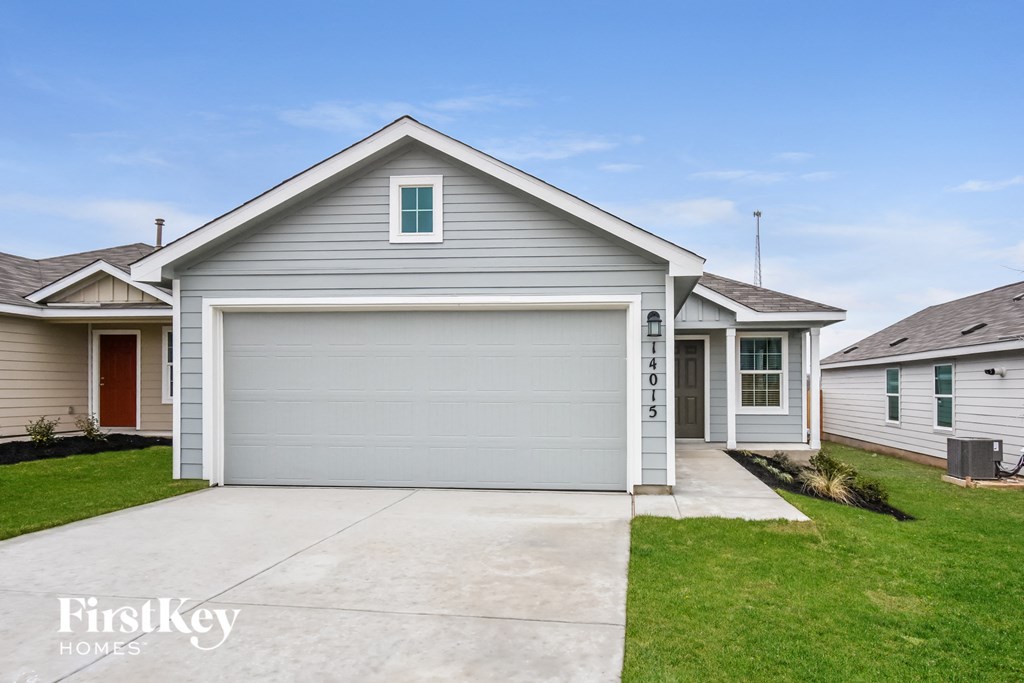 A two-story house with a garage is for sale.