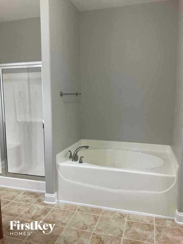 a bathroom with a bath tub and a shower