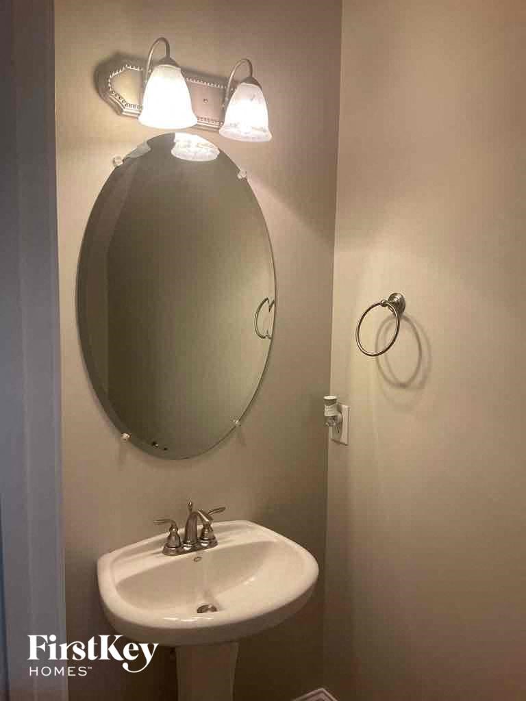 a bathroom with a mirror and a sink