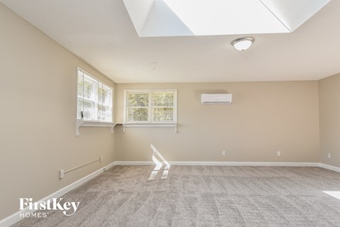 the living room is spacious and has a skylight