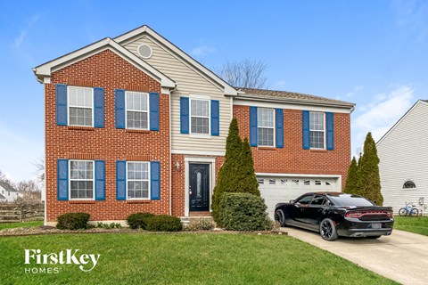 a house with a black car parked in front of it