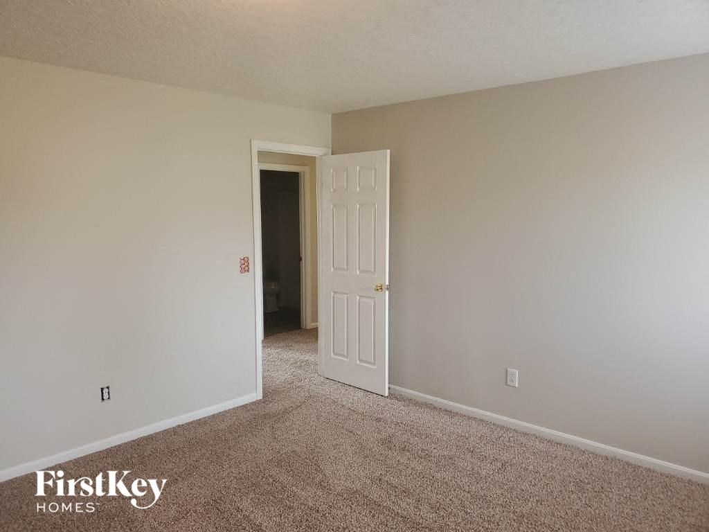 the living room of an empty house with a white door