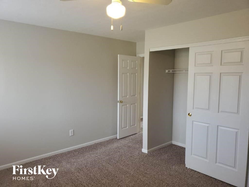 a bedroom with white doors and a closet and a door to a closet