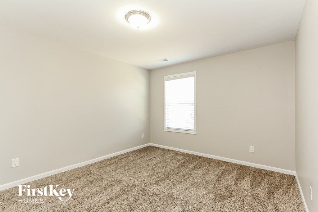the second bedroom with carpet and a window