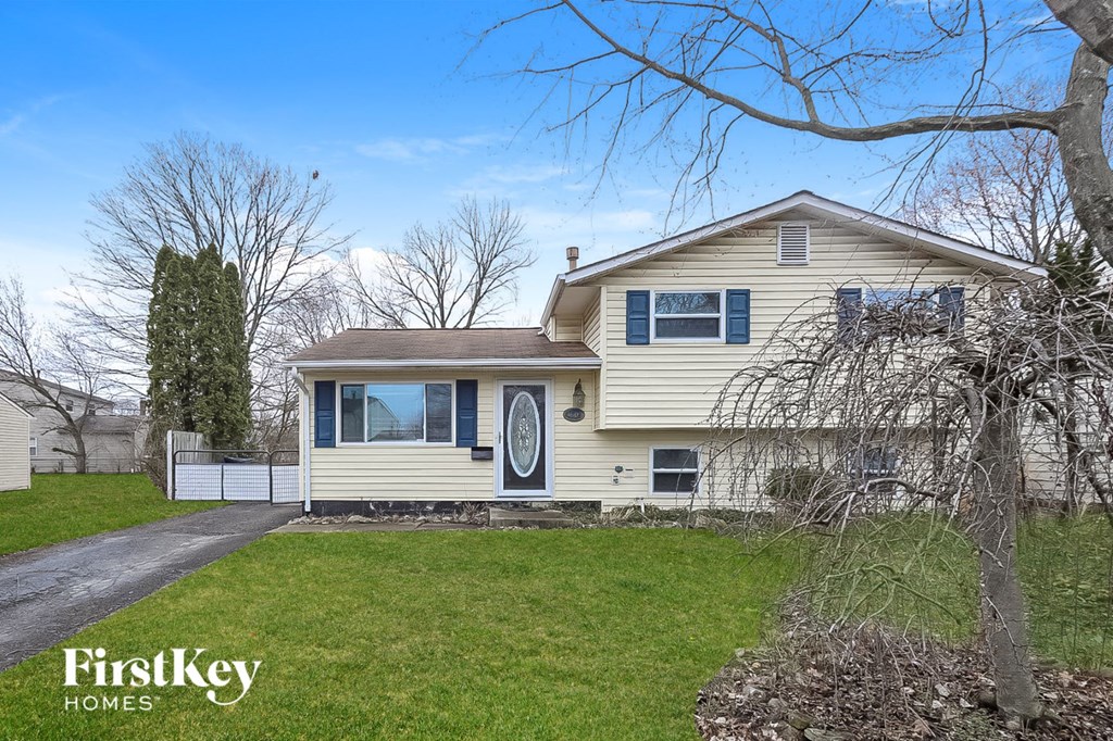 A house with a tree in front of it.