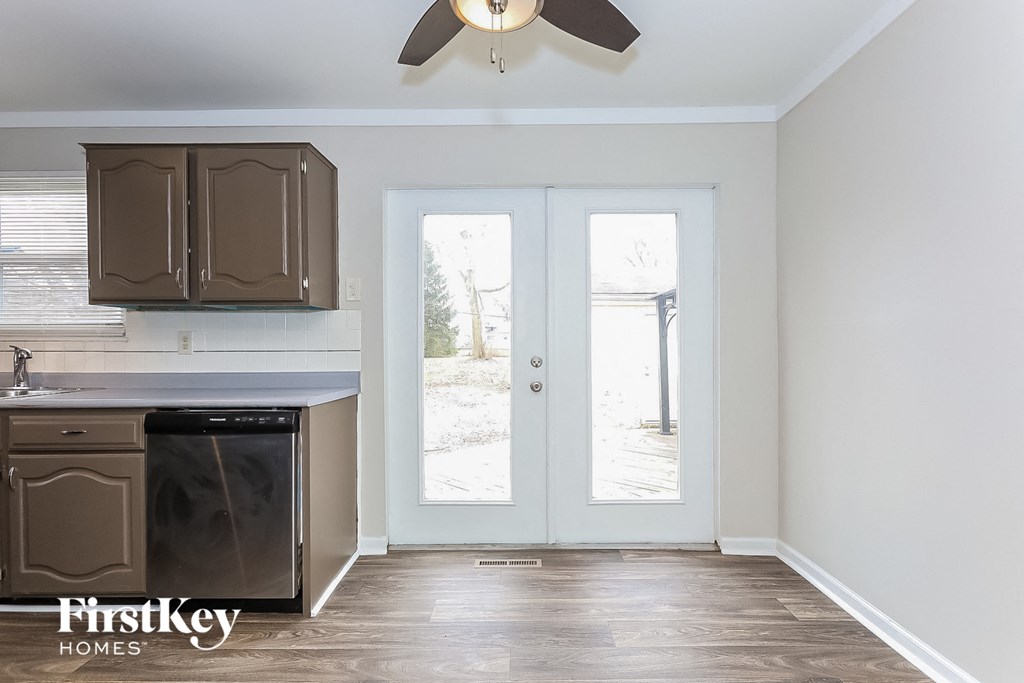 A kitchen with a dishwasher and a fan.