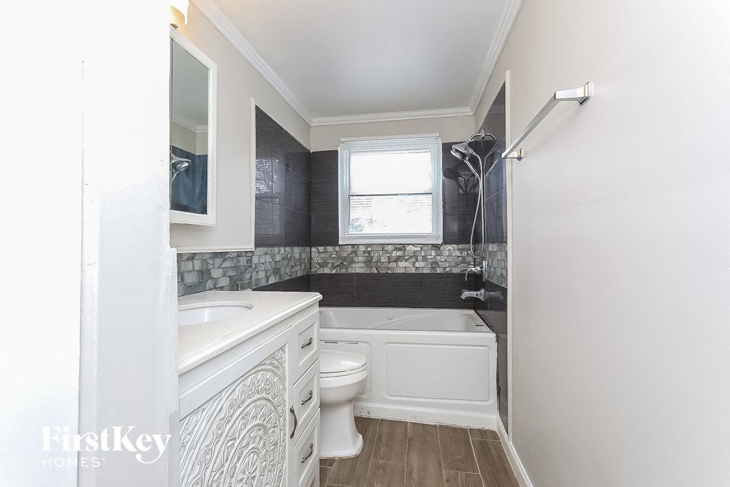 A bathroom with a white toilet and a white sink.