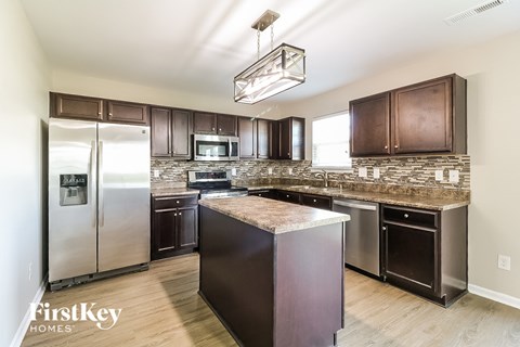 a modern kitchen with stainless steel appliances and granite counter tops