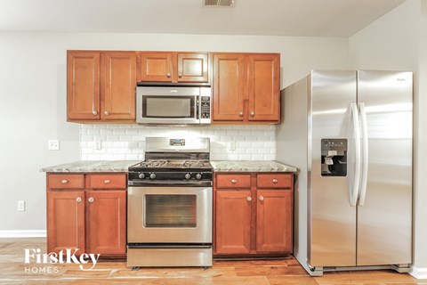 a kitchen with wooden cabinets and stainless steel appliances