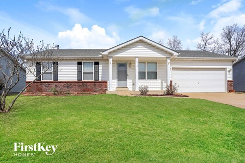 a white house with a lawn in front of it
