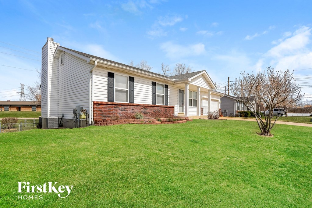 a white house with a lawn in front of it