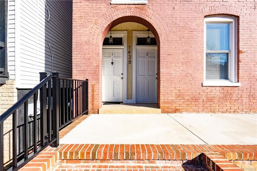 the front door of a brick building with a blue door