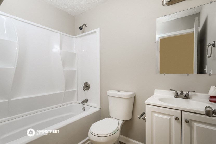 a bathroom with a sink toilet and a bath tub