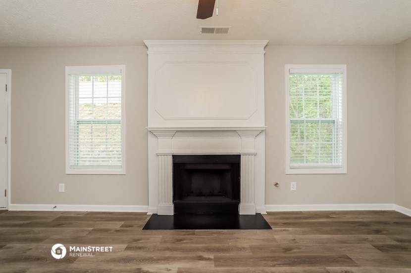 the living room of a new home with a fireplace