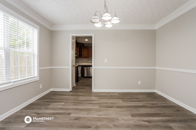 the spacious living room with a view of the kitchen and dining room