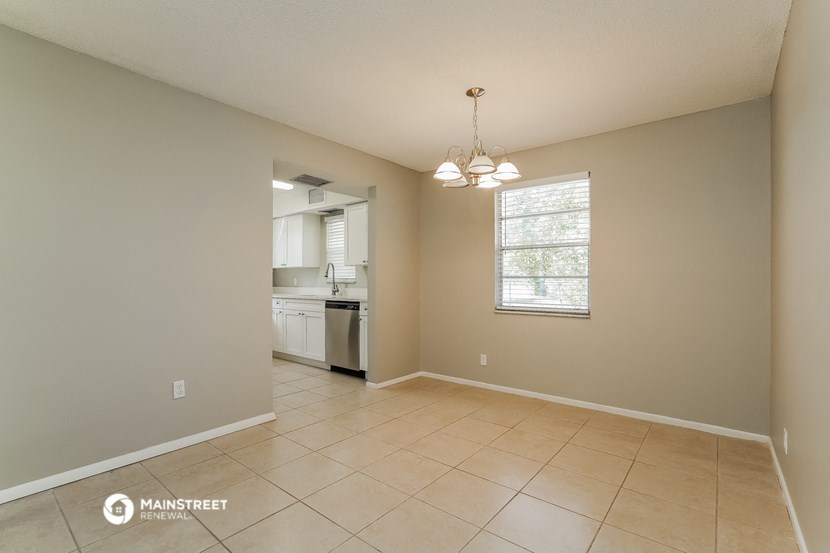 the spacious living room and kitchen in this home