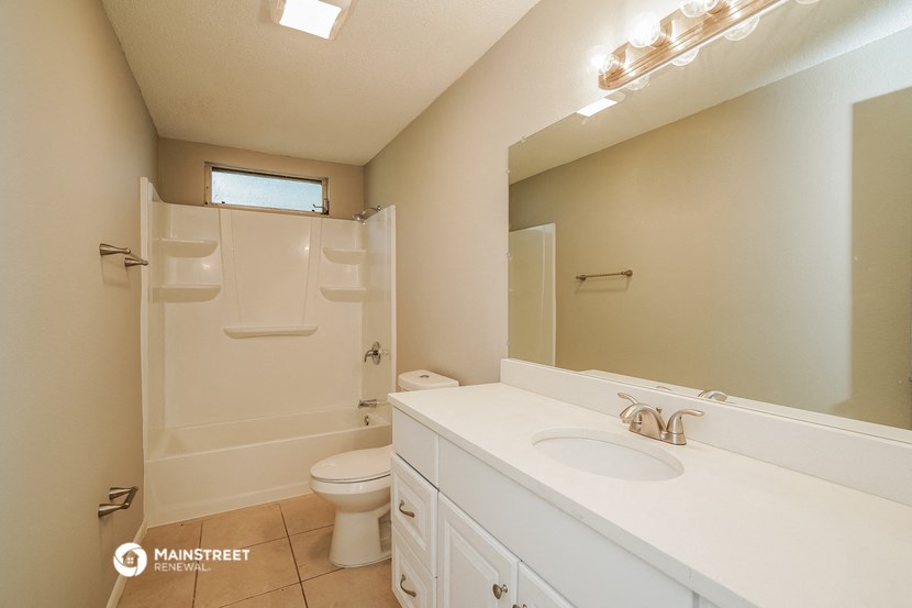 a bathroom with a sink and a shower and a toilet